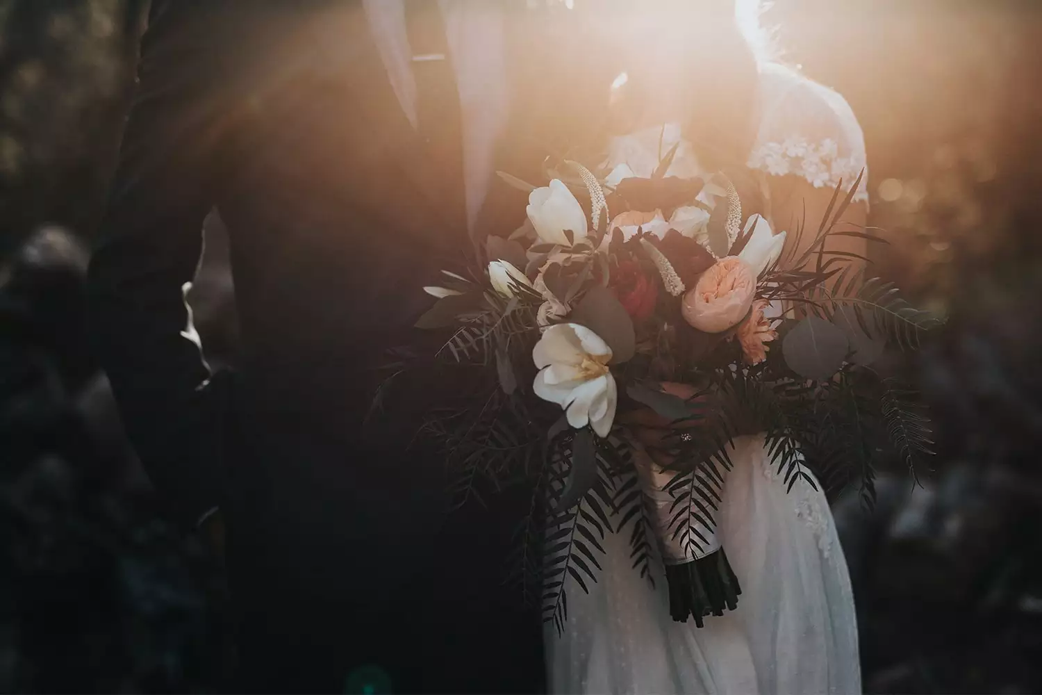 Destination wedding in Ireland — bride holding a seasonal bouquet beside the groom during an autumn wedding celebration.