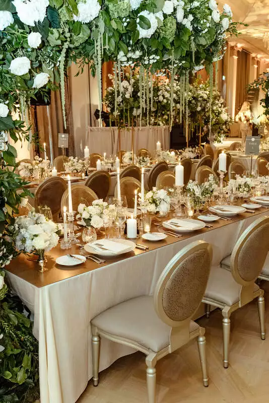 Wedding table design with white floral arch in Adare Manor ballroom, designed by wedding planner Olivia Buckley International