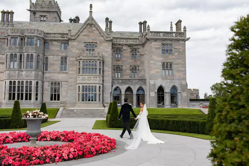 Bride and Groom walking towards Adare Manor during their wedding planned by luxury wedding planner Olivia Buckley International