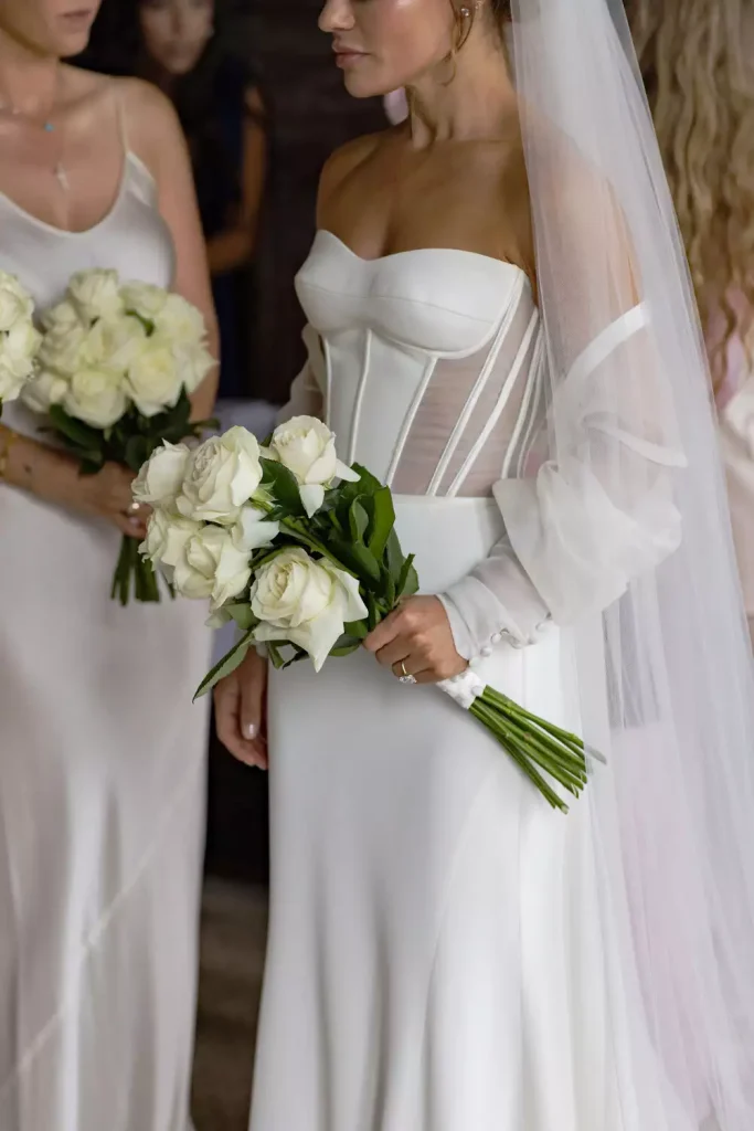 Destination wedding at Adare Manor, County Limerick — bride in her gown wearing a veil and holding a bouquet of white roses.