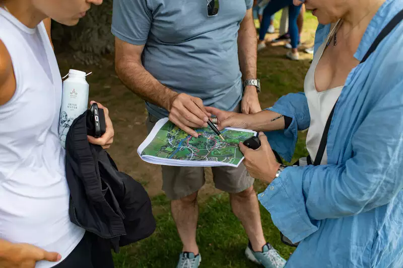Destination wedding in Ireland at Adare Manor, County Limerick — guests taking part in a treasure hunt on the castle grounds, holding and reviewing a map of the estate.