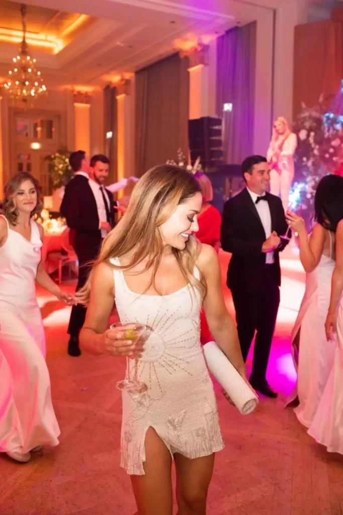 Destination wedding at Adare Manor, County Limerick — bride celebrating during the wedding party, wearing a mini dress with embroidered detailing.