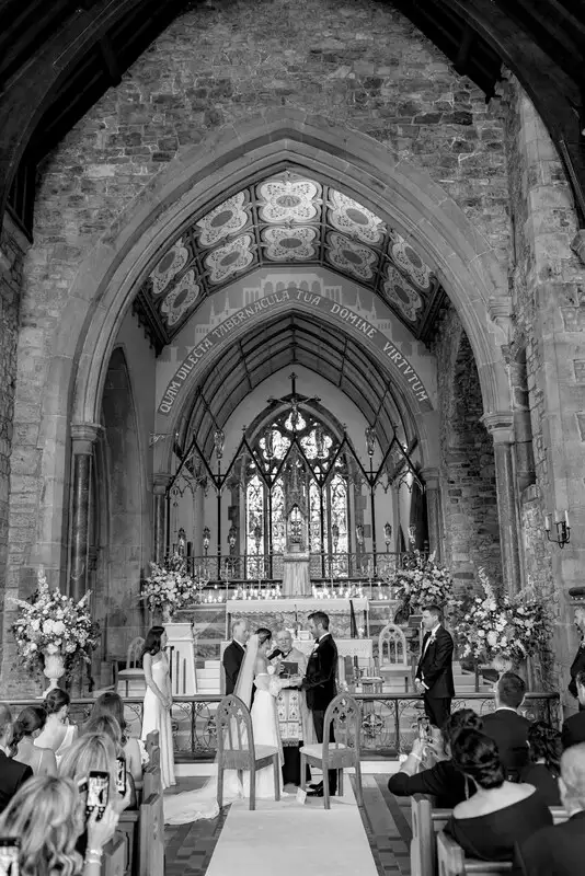 Irish destination wedding at Adare Manor, County Limerick — bride and groom standing at the altar during a church wedding ceremony.