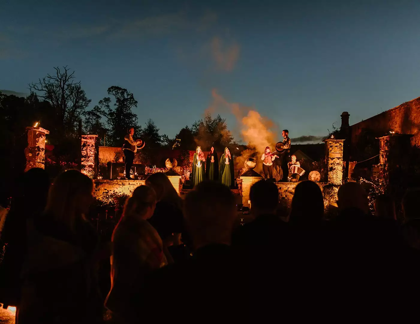 Private celebration in Ireland — Irish entertainment performers on a lit stage during an evening party, with guests watching the live performance.