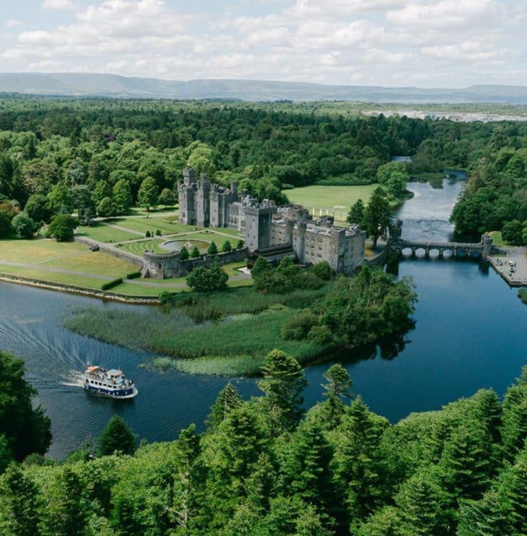 Drone shot of Ashford Castle overlooking Lough Corrib during summer.