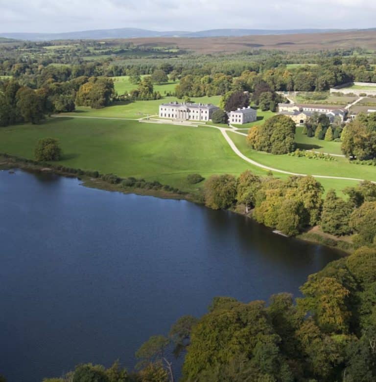 Drone shot of Ballyfin Demesne overlooking lake during spring.