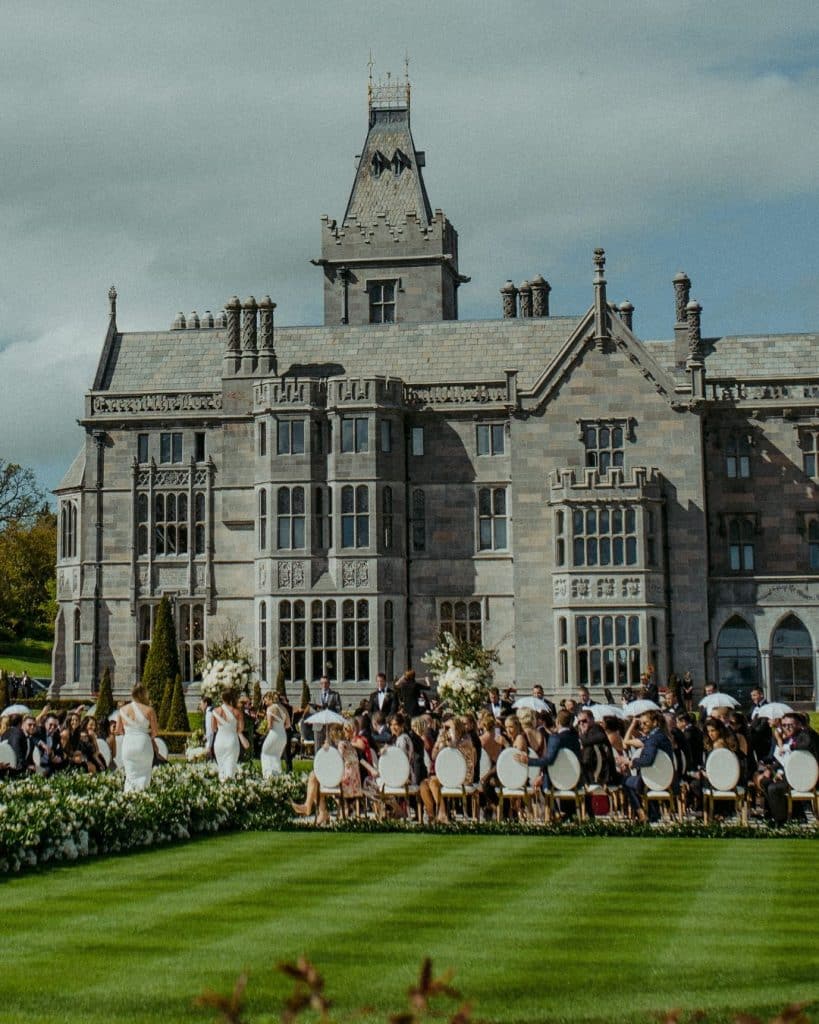 Wedding ceremony in the formal gardens of Adare Manor during a destination wedding in Ireland.