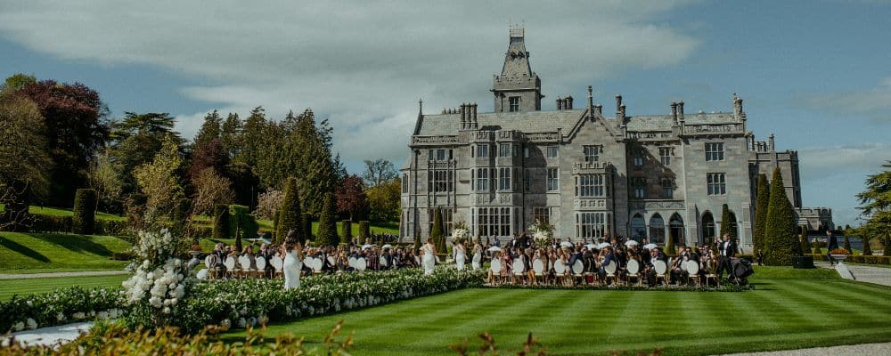 Wedding ceremony in the formal gardens of Adare Manor during a destination wedding in Ireland.