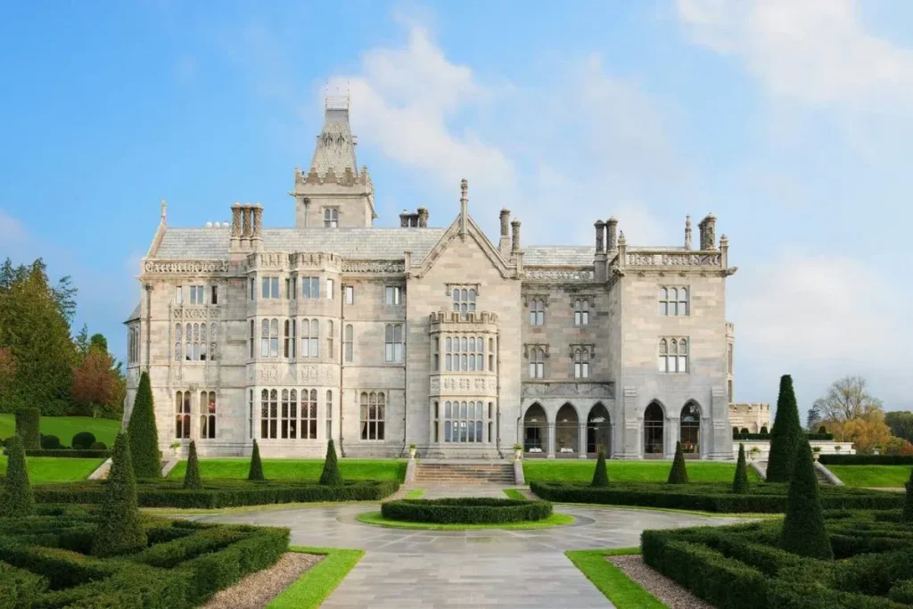 Destination wedding in Ireland at Adare Manor, County Limerick — estate façade viewed across the formal gardens of the Forbes Five-Star resort.