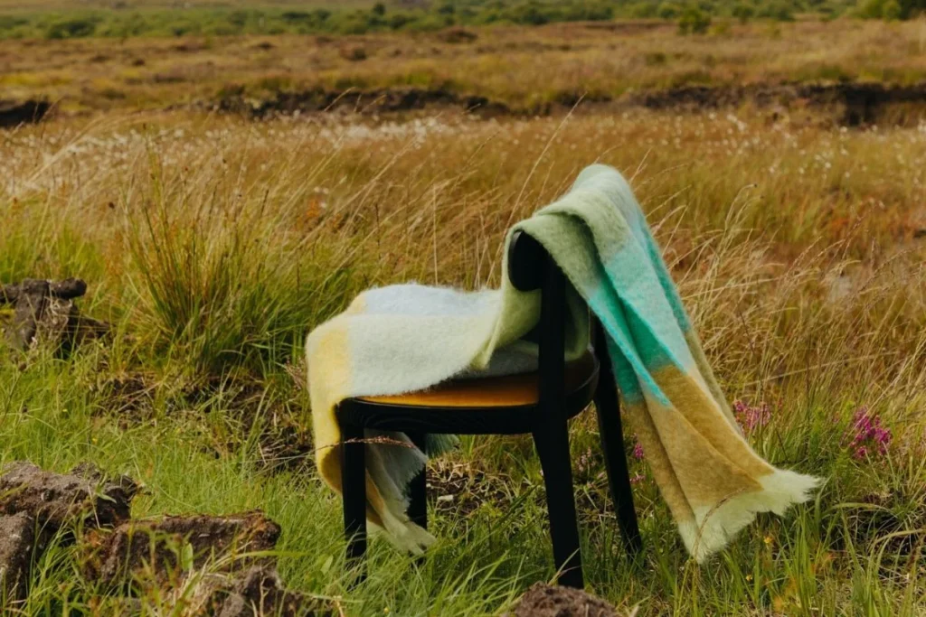 Irish heritage design — Foxford Woollen Mills scarf styled within the landscape of remote Ireland for destination wedding hospitality and guest comfort.