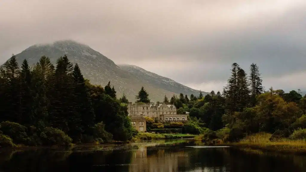 Destination wedding in Ireland at Ballynahinch Castle, County Galway — castle exterior overlooking the Owenmore River and Connemara mountains.
