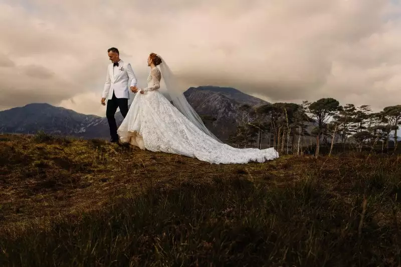Destination wedding in Ireland at Ballynahinch Castle, County Galway — bride and groom on the Connemara moorlands during an outdoor wedding celebration.
