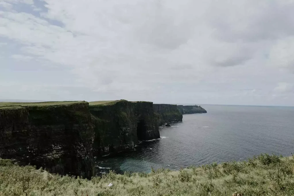 Destination wedding in Ireland — guests visiting the Cliffs of Moher along the Wild Atlantic Way during a wedding weekend in Ireland.