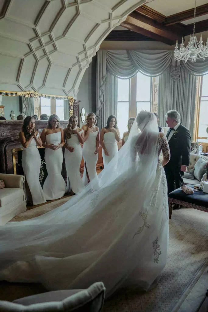 Destination wedding at Adare Manor, County Limerick — bride sharing a first look with her bridesmaids inside a grand suite before the ceremony.