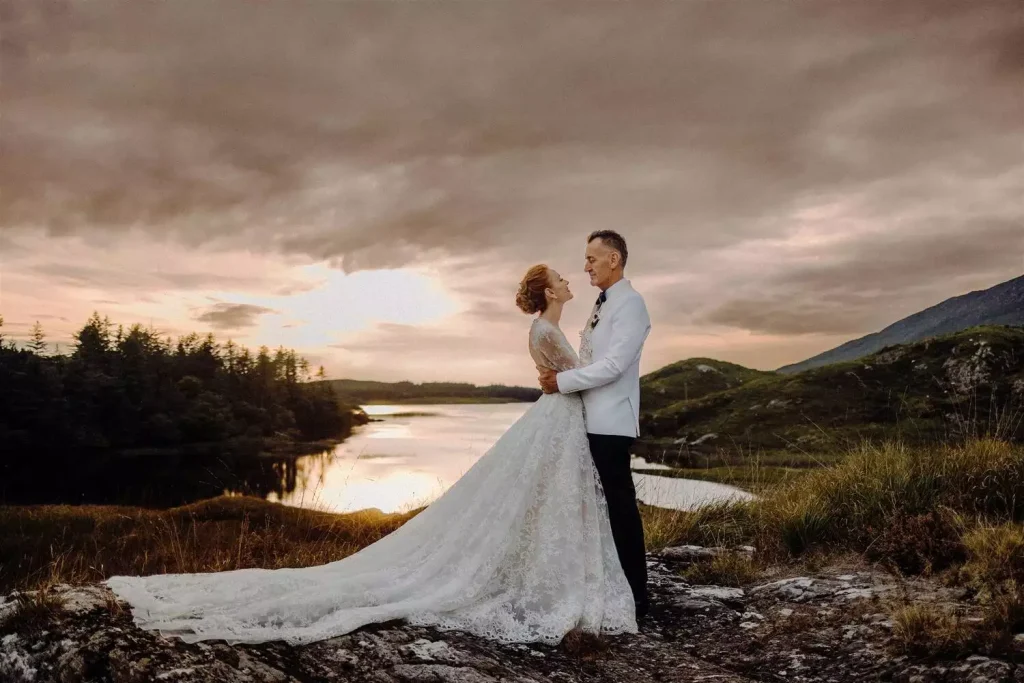 Destination wedding in Ireland at Ballynahinch Castle, County Galway — bride and groom portraits overlooking a Connemara lake during an evening celebration.