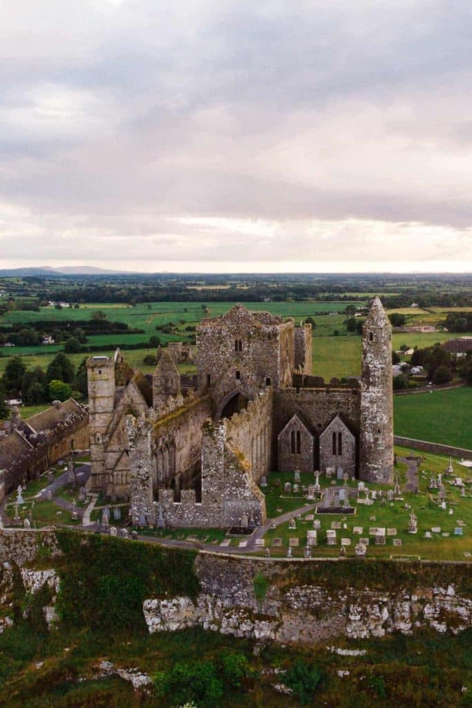 Destination wedding in Ireland, Cashel Palace, County Tipperary — the Rock of Cashel on a limestone hilltop above the Golden Vale, featuring medieval stone ruins and a round tower set against open rural landscape.