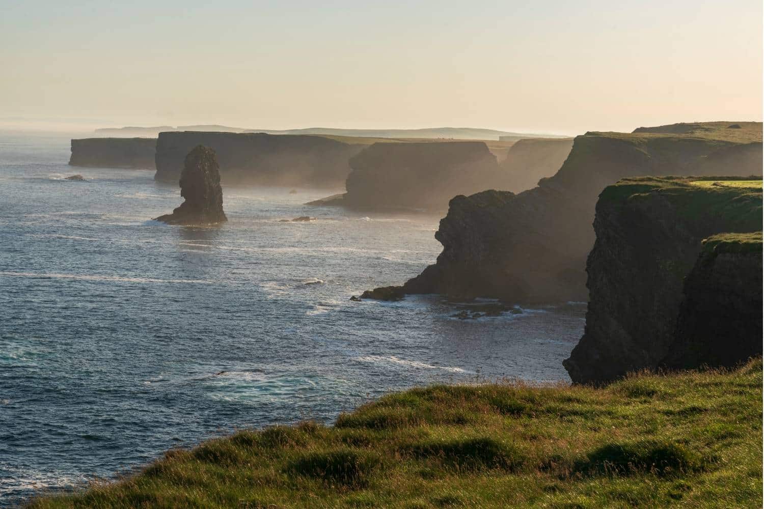 Aerial view of the Cliffs of Kilkee at sunrise, showcasing Ireland’s Wild Atlantic Way for a luxury destination event in County Clare.