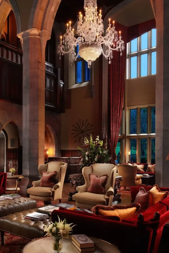 Irish castle wedding at Adare Manor — Oak Hall interiors with carved wood panelling, ornate chandelier lighting, and upholstered seating within the manor house.