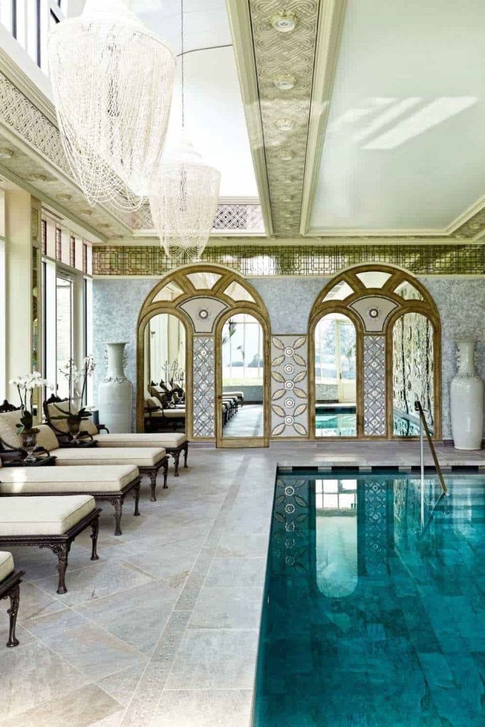 Castle wedding in Ireland at Ashford Castle, County Mayo — ornate spa interior with indoor pool, lounge chairs, and bright natural light throughout the wellness space.