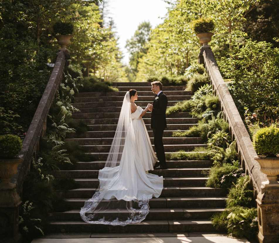Irish castle wedding at Ashford Castle, County Mayo — outdoor ceremony on the Long Walk overlooking the estate grounds.