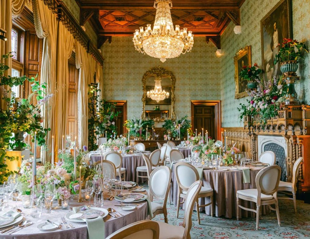 Castle weddings Ireland at Ashford Castle, County Mayo — formal dining setting in the Connaught Room beneath chandeliers and historic interiors.