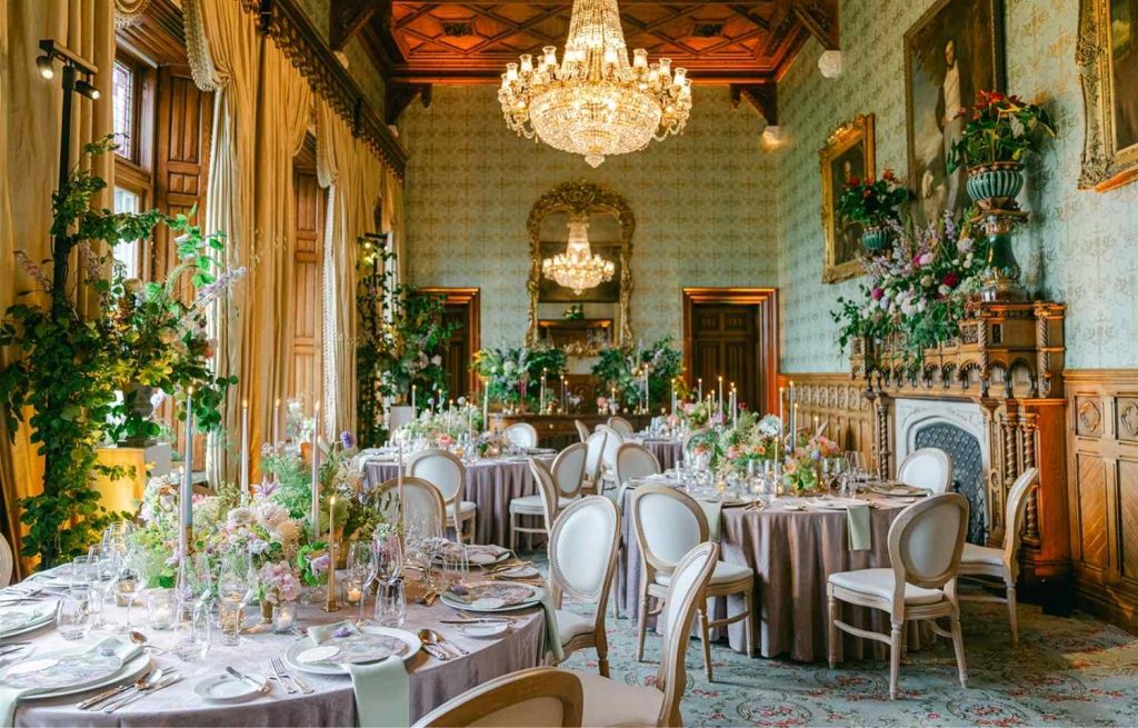 Destination wedding in Ireland at Ashford Castle, County Mayo — intimate wedding dinner in the Connaught Room with floral design throughout the historic reception space.