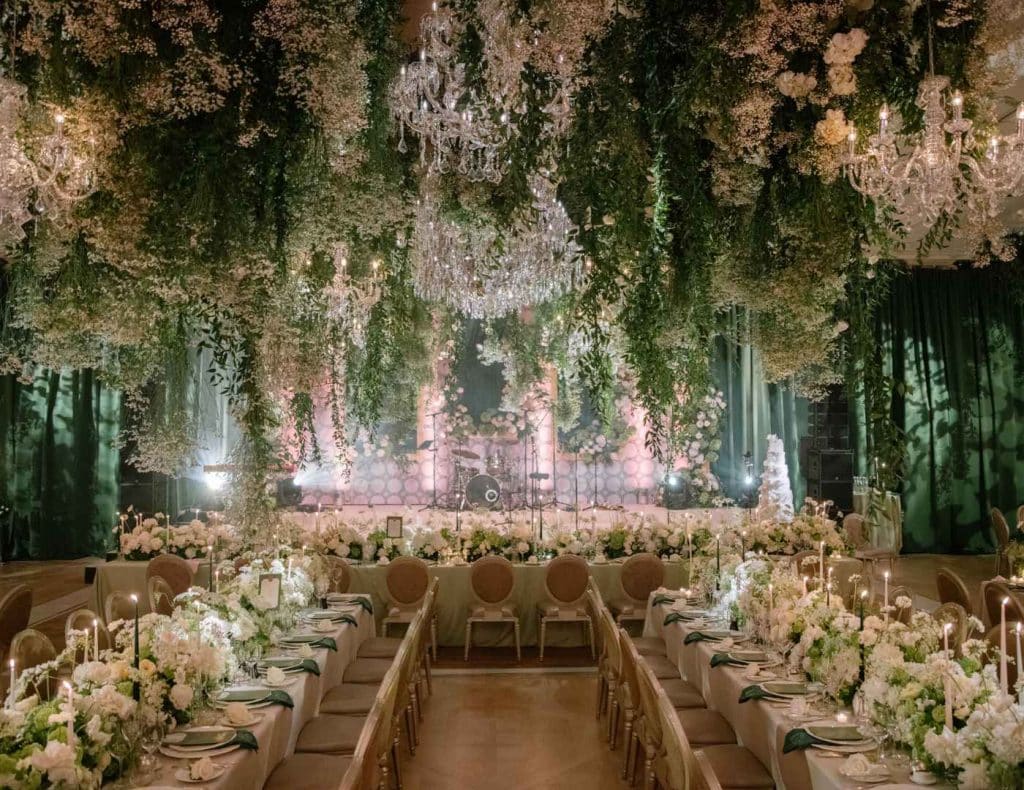 Alt description Estate wedding in Ireland at Adare Manor — ballroom reception with suspended floral installations and immersive dining design for a multi-day destination wedding.