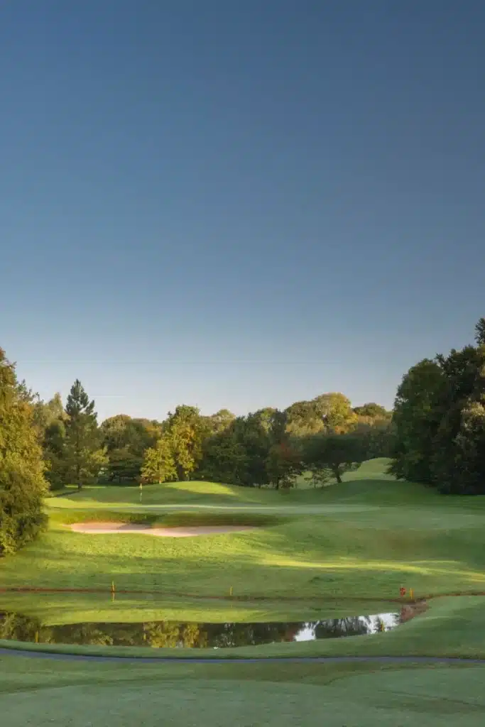 Irish destination wedding at Mount Juliet Estate, County Kilkenny, Ireland — golf course landscape with manicured lawns, mature trees, and clear blue skies across the estate grounds.