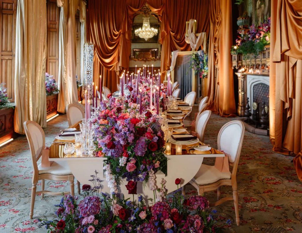 Private celebration at Ashford Castle, County Mayo — long-table dining design with cascading floral arrangements in the Connaught Room.