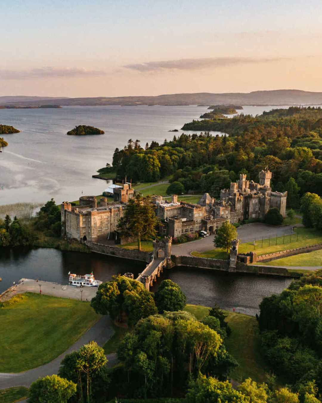 Press release announcing the strategic marketing partnership between Ashford Castle and Olivia Buckley International, illustrated by a view of the Ashford Castle estate and Lough Corrib.