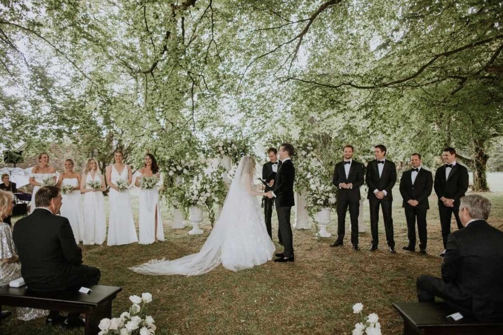 Bridal Guide feature on wedding planning priorities and creating a meaningful ceremony experience, illustrated by an outdoor wedding ceremony in the woodland gardens at Lough Eske Castle.