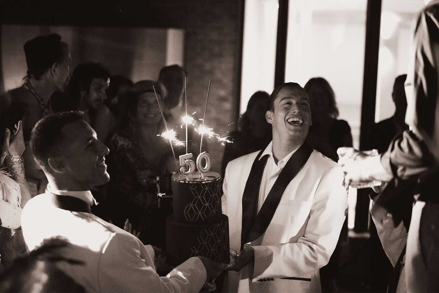 Milestone celebration in Ireland — 50th birthday cake presentation during a private celebration at a private residence.