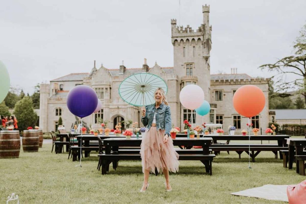 Private celebration in Ireland at Lough Eske Castle — family gathering on the castle lawns with colourful balloons and outdoor event styling.